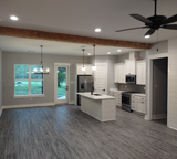 Open concept construction on Million Dollar Road Farmhouse by MCM Homes, LLC